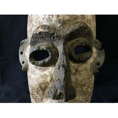 an old mask with holes in the middle