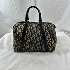 Measurements are 12" wide, 7"5 high, 6"2 deep with two 11"5 handles each with a 4" drop. On the interior there is one main compartment lined in vinyl, back zipper pocket and a top zipper closure. Bag has silver tone hardware with navy blue leather trim and you can see the Dior logo on the exterior. Please note bag is not new and is exactly as pictured and is 100% authentic Dior made in France. This lovely Dior bag is a great vintage find with no tears and light rubbing on bottom corners with no holes. Bag comes with the inner Scotchgard label on the interior and the top zipper was professionally replaced. If you need more pictures please let me know. Contact If you have zero, excessive or hidden feedback please email me. Items are sold as is and if you have an questions please let me know Dior Vintage Bag, Dior Logo, Vintage Christian Dior, Leather And Canvas, Bags Vintage, Satchel Bag, Vintage Bags, No Tears, Vintage Dior