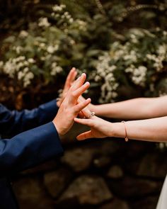 the bride and groom are holding their hands together