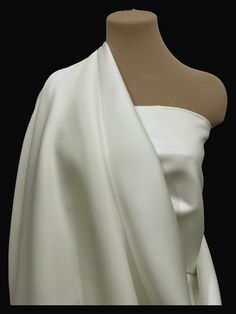 a white dress on a mannequin with a black background