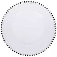 a white plate with black dots on the rim