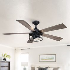 a ceiling fan in a bedroom with white walls