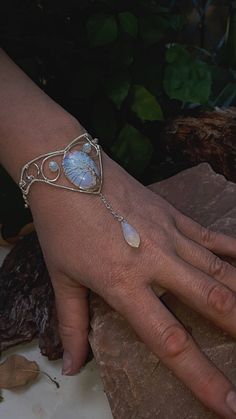 "Moonstone (Opalite) tree of life cuff Bracelet, Silver wire wrapped Tree of life bracelet Fits all sizes 5.5\"-7.5\" Can order in your size or request a size that suites your desire.  This beautiful Tree of Life bracelet is hand-crafted jewelry with Opalite  and Silver plated wire; Opalite is a milky man-made stone of translucent glass and crushed opals. It can transform from a rainbow sheer to a bright blue to flashy yellow depending on the light. The bracelet in the photos was shot in natural Elf Jewelry Bracelet, Moonstone Moon Magic Jewelry, Wire Mandala Bracelet, Handmade Jewelry Bracelets Wire, Tree Of Life Stone Wrapping, Creative Crystal Jewelry, Viking Wedding Jewelry Women, Wire Tree Jewelry, Wire Wrapped Jewelry Stones