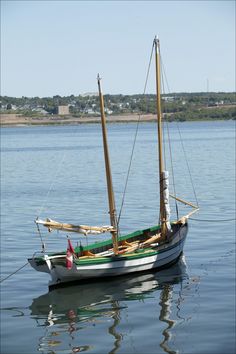 a small boat floating on top of a body of water