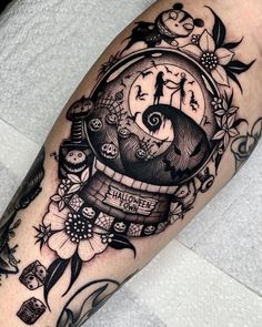 a black and white photo of a clock with flowers on it's arm,