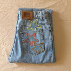 "Reworked vintage light wash mom jeans. These jeans are reworked with handmade star patches in a mainly yellow and orange color pallate.  All pockets are fully functional.  Original jeans are by Liz Wear. 100% cotton, made in Phillipines.  Marked a size 10 Petite- 29\" waist, 11.5\" rise, 39\" hips, 26\" inseam, 14\" leg opening.  In great vintage condition with some very light vintage wear." Patchwork Star, Light Wash Mom Jeans, Star Patches, Patchwork Hoodie, Reworked Denim, Patchwork Clothes, Star Vintage, Diy Jeans, Vintage Mom Jeans