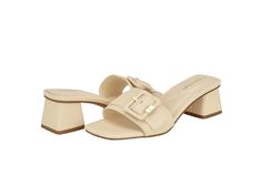 Calvin Klein Ariella - Women's Shoes : Ivory : Breathable and comfortable, the Calvin Klein Ariella sandals are the perfect choice to style up your different outfits. The polyurethane upper features an adjustable buckle closure that ensures a perfect. These stylish sandals come with foam insole and polyurethane lining that makes them comfortable to wear all day. A great addition to your footwear collection, these heeled sandals work for different occasions. Slip-on style. Open, square toe design. Block heels. Synthetic rubber outsole. Imported. Measurements: Heel Height: 1 10 13 in Product measurements were taken using size 7, width M. Please note that measurements may vary by size. Cream Mules With Padded Block Heel, Cream Block Heel Mules With Padded Heel, Chic Beige Sandals With Buckle Closure, Formal Beige Mules With Buckle Closure, Cream Closed Toe Sandals With Buckle Closure, Elegant Beige Flat Sandals, Beige Flat Sandals With Heel Strap, Beige Open Toe Mules With Heel Strap, Chic Beige Mules With Cushioned Footbed