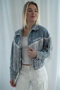 Our fringe detail denim jackets can be customized with your text to make for a one of a kind special item. Be the life of the party with the fun fringe details on these jackets with a lightweight fit and signature cotton denim feel. We suggest sizing up as these run on the smaller side. This item ships in 10-14 days. Product Care💓 Please hand wash with care. Do not iron directly on personalization. Bohemian Denim Jacket With Frayed Hem, Spring Festival Denim Jacket With Fringe, Summer Cotton Fringe Outerwear, Bohemian Cotton Denim Jacket With Frayed Hem, Spring Festival Outerwear With Frayed Hem, Trendy Summer Outerwear With Fringe, Trendy Summer Fringe Outerwear, Denim Outerwear With Frayed Hem For Festival, Festival Denim Jacket With Fringe And Long Sleeves