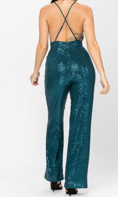 All over sequin, sleeveless, bodycon jumpsuit with a v-neckline, spaghetti straps, and a wide leg 100% POLYESTER Green Wide Leg Jumpsuits And Rompers For Party, Green Wide-leg Jumpsuits For Party, Green Wide Leg Jumpsuits For Party, Party Strapless Stretch Jumpsuit With Wide Leg, Party Strapless Stretch Wide Leg Jumpsuit, Party Strapless Wide Leg Stretch Jumpsuit, Party Wide Leg Stretch Strapless Jumpsuit, Glamorous Green Jumpsuits And Rompers For Evening, Glamorous Green Bottoms For Party Season