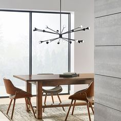 a dining room table with chairs and a chandelier hanging from it's ceiling