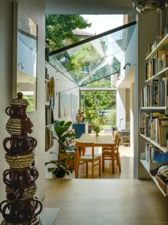 an open room with a table and bookshelf filled with lots of books in it