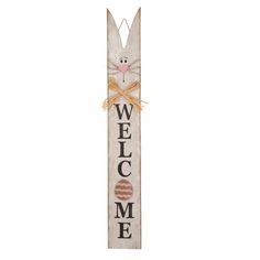 a wooden sign that says welcome home with a bunny face on the front and bottom