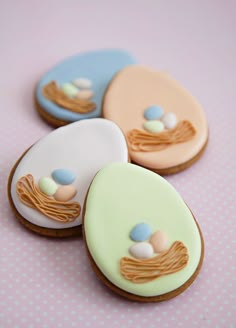 three decorated cookies sitting on top of a table