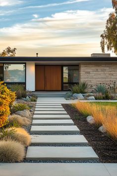 a modern home with stone steps leading to the front door