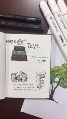 an open book with travel drawings and markers on the pages next to it are pencils