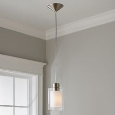 a light fixture hanging from the ceiling in a room with gray walls and white trim