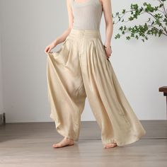 "Cool and comfortable for hot summer days, this apricot wide leg pants is elegant and stylish.    It is a wonderful wardrobe staple that's a timeless classic you'll wear again and again.  All our items are Tailored and Handmade and Made to Order ,I can make Any Size . I design new styles every week, please collect my store. I believe that you will meet your favorite styles. ★★FEATURES Tencel flax Has lining Two side pockets Front zipper closure Wide leg pants Apricot pants Casual pants Long pant Bohemian Summer Pants In Solid Color, Bohemian Summer Pants, Spring Summer Harem Pants With Relaxed Fit, Baggy High Waist Harem Pants For Vacation, Baggy Summer Vacation Pants, Summer Vacation Baggy Pants, Baggy Summer Vacation Bottoms, Summer Cotton Wide Leg Harem Pants, Summer Wide Leg Cotton Harem Pants