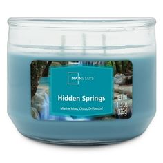 a jar of blue colored candles with the label hidden springs on it's lid