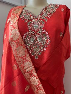 This is a beautiful 3 piece Kurta Set in Chinnon Silk  . The Kurta is lined with embroidered neckline and butti work all over the front . Dupatta for this is in Banarsi Silk with motifs all over. This is perfect addition to any special occasion or festival . Perfect for Diwali , Eid , Rakhi , Holi, Karwa Chauth, Navratri Celebrations !! Unstitched Cotton Silk Sets With Gota Work, Bollywood Style Unstitched Cotton Silk Suit With Gota Work, Navratri Cotton Silk Sets With Dupatta, Traditional Cotton Silk Churidar With Gota Work, Slub Silk Sets With Resham Embroidery For Puja, Traditional Drape Salwar Kameez With Gota Work For Diwali, Festive Cotton Silk Palazzo Set With Dupatta, Straight Kurta Anarkali Set With Gota Work, Bollywood Style Unstitched Slub Silk Suit With Gota Work