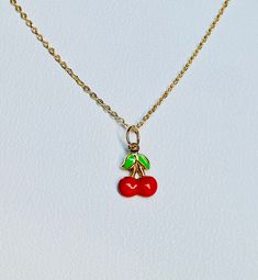 "A beautiful 14K solid yellow gold Red Cherry puffy charm / pendant with hand painted and baked enamel. It has a soldered ring to attach to a bracelet or a necklace. The small pendant measures 10mm (0.39\") tall with bail and without the soldered ring and 7.3mm (0.29\") wide. It can be used as a necklace pendant or a bracelet charm and would make a perfect gift. The pendant can be paired with a shiny 14K Yellow Gold 1.2mm cable link chain in either 16\" or 18\" length or with a 16\" 14K gold-pla Cute Gold Jewelry With Charms, Everyday Gold Enamel Jewelry, Handmade Yellow Gold Charms For Gifts, Handmade Yellow Gold Charms As Gifts, Green Enamel Jewelry With Charms, Green Enamel Charm Jewelry, Cute Gold Enamel Jewelry, Cute Round Red Jewelry, Cute Red Round Jewelry