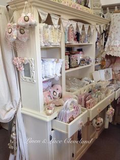 a room filled with lots of baby items and decor on display in it's shelves