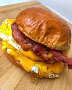 a bacon, egg and cheese sandwich on a wooden cutting board