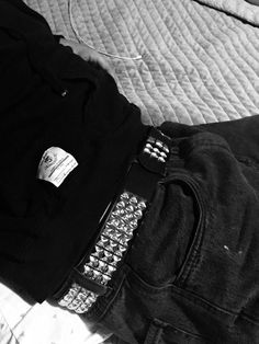 a black and white photo of someone's pants with a cell phone attached to them