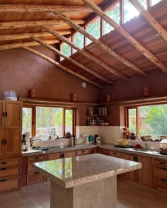 a large kitchen with wooden cabinets and counter tops in the middle of an open floor plan