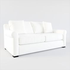 a white couch with four pillows on it