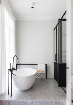 a white bath tub sitting next to a walk in shower