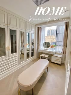 a bath tub sitting next to a window in a room with white walls and cabinets