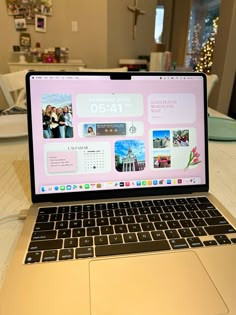 an open laptop computer sitting on top of a wooden table next to a white plate