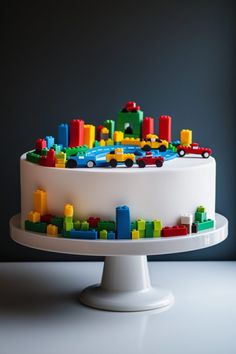 a white cake topped with legos on top of a table