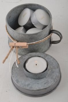 a candle holder made out of concrete with some tea lights in it and tied around the base