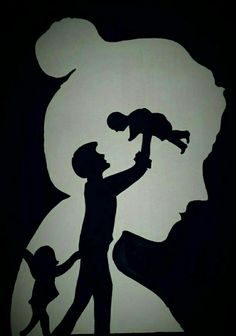 the silhouette of a man holding a child in his arms