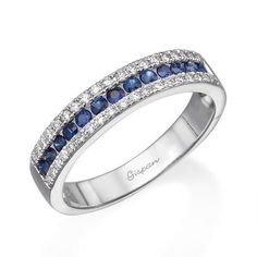 a white gold ring with blue sapphires and diamonds on the sides, set in 18k white gold