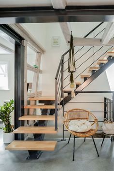 a room with some stairs and chairs in it