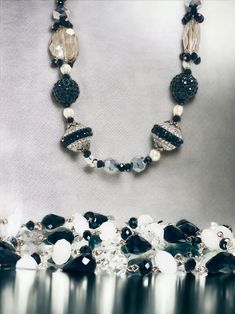 Indulge in the allure of bygone eras with our Vintage-Looking Black and White Costume Jewelry Necklaces. This necklace brings a touch of nostalgia and classic charm to your modern style, making it a must-have for lovers of vintage aesthetics.  With its vintage-inspired design and classic color palette, this necklace is the perfect accessory to transform any outfit into a masterpiece of timeless beauty. Whether you're attending a themed event or simply adding a touch of vintage charm to your dail