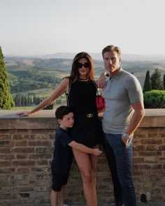 a man and woman posing for a photo with a young boy