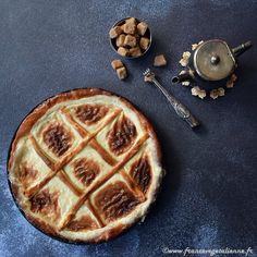 a pie sitting on top of a table next to a measuring cup and spoons