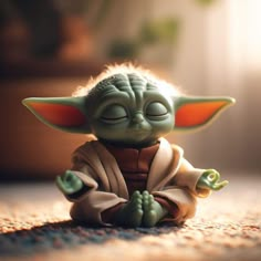 a baby yoda doll sitting on the ground