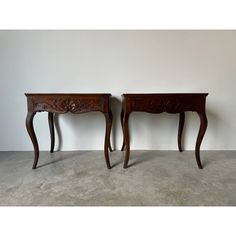 two wooden tables sitting next to each other