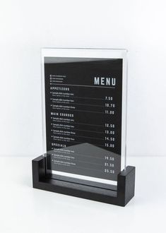 a black and white menu holder on a table