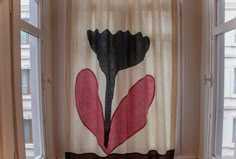 a curtain with a flower drawn on it in front of a window