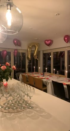 the table is set with wine glasses and candles for valentine's day dinner party