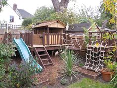 a backyard with a tree house and slide