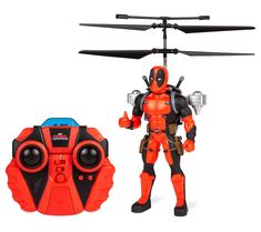 a toy helicopter with a deadpool figure next to it's remote control case