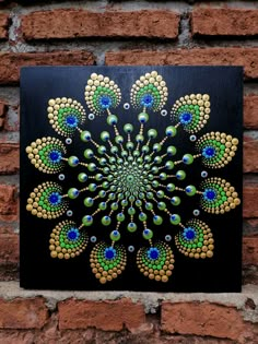 a painting on the side of a brick wall depicting a peacock's tail pattern