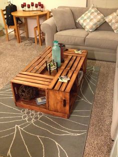 a coffee table made out of pallet wood in a living room with couches