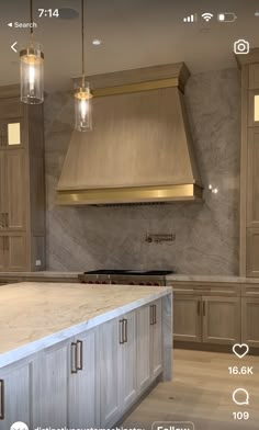 a kitchen with marble counter tops and gold hoods on the wall above it is an appliance